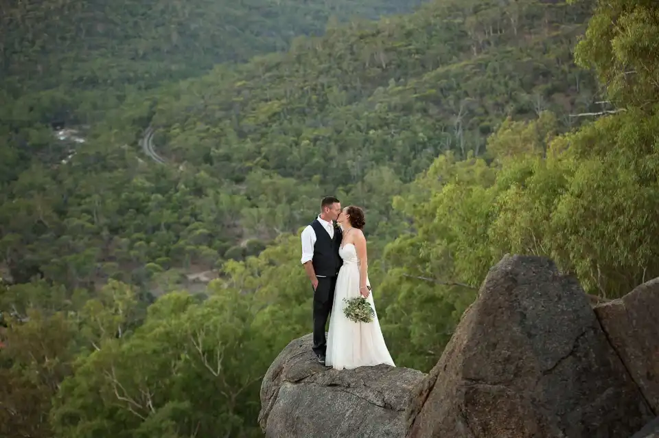 Simone Harris Photography - Bride and groom standing on a rock ledge